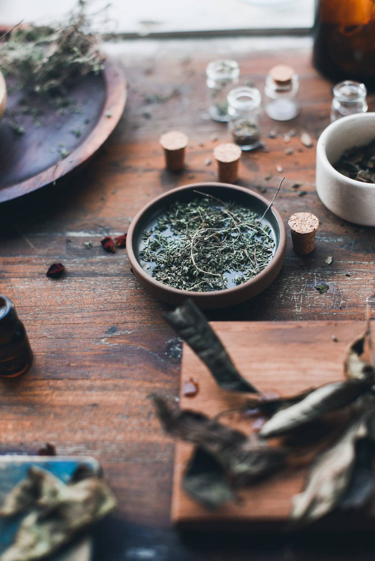 A bowl of dried herbs on a rustic wooden table