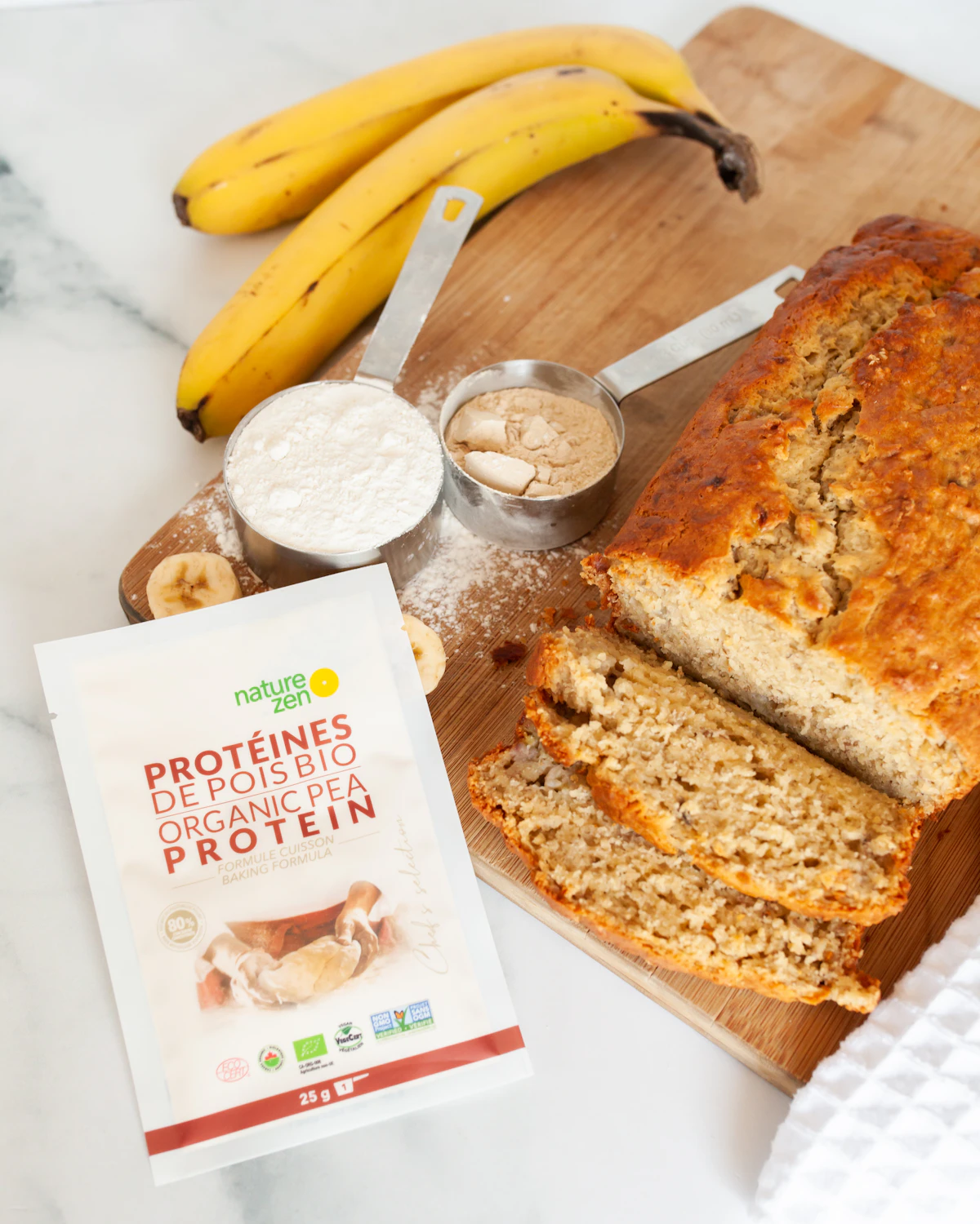 A pea protein pouch next to banana bread and baking ingredients
